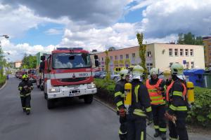Chlapec před požárem utekl na balkon, zachránili ho hasiči se žebříkem